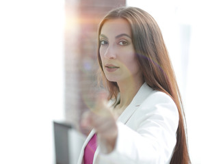 confident business woman pointing finger forward