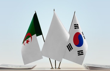 Flags of Algeria and South Korea with a white flag in the middle