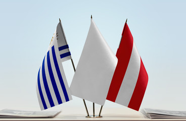 Flags of Uruguay and Austria with a white flag in the middle