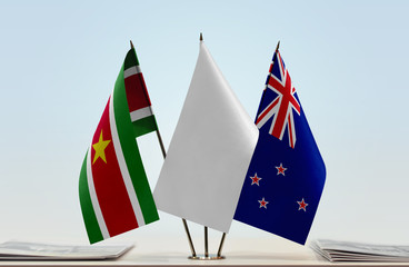 Flags of Suriname and New Zealand with a white flag in the middle