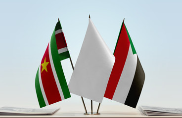 Flags of Suriname and Sudan with a white flag in the middle