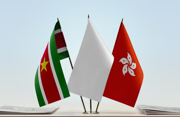 Flags of Suriname and Hong Kong with a white flag in the middle