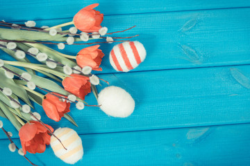 Obraz premium Vintage photo, Tulips, catkins and eggs wrapped woolen string as festive Easter decoration