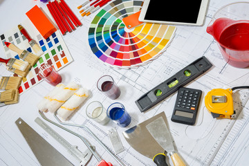 Professional decorator using a digital tablet, work tools.