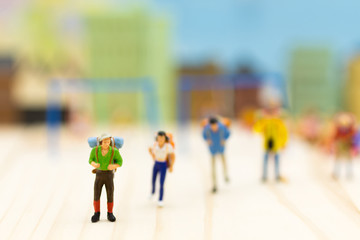 Miniature people: Travelers standing on white background , Image use for travel concept.