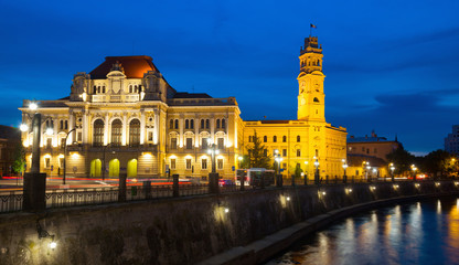 Fototapeta na wymiar Oradea City Hall on embankment in twilight