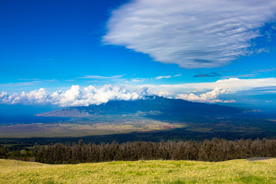 Grand view of the island of Maui in Hawaii, with Maalaea Bay on the left and Kalului Bay on the right and the volcano Mauna Kahalawai of the West Maui Mountains in the center, with spectacular clouds