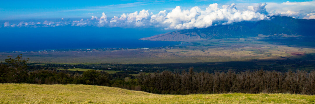 Ma'alaea Bay and Puu Kukui, the cloud-shrouded volcano on the north end of the island of Maui in Hawaii, photographed from Haleakala, the other volcano on the island