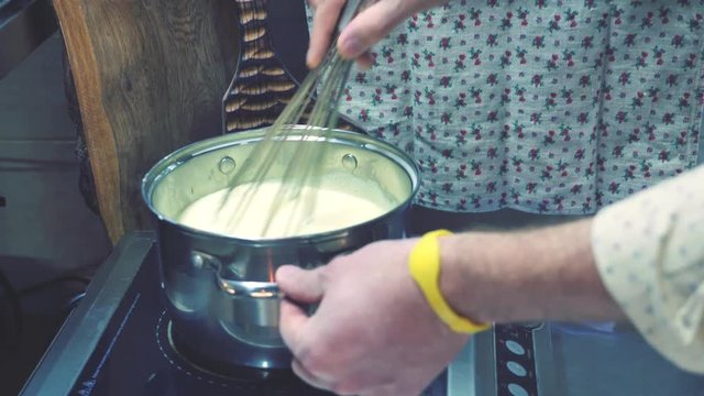 Closeup footage of Shef cooking sweet cream souffle