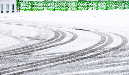 Car tire track on snow in the winter road