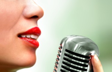 Women singing using microphone