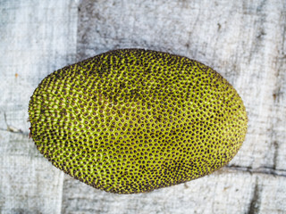 closeup of fresh jackfruit plant with green skin at a market from above