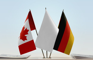 Flags of Canada and Germany with a white flag in the middle