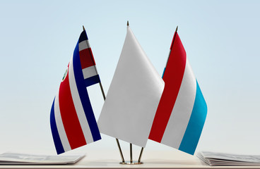 Flags of Costa Rica and Luxembourg with a white flag in the middle