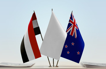 Flags of Yemen and New Zealand with a white flag in the middle