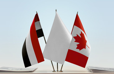 Flags of Yemen and Canada with a white flag in the middle