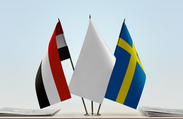 Flags of Yemen and Sweden with a white flag in the middle