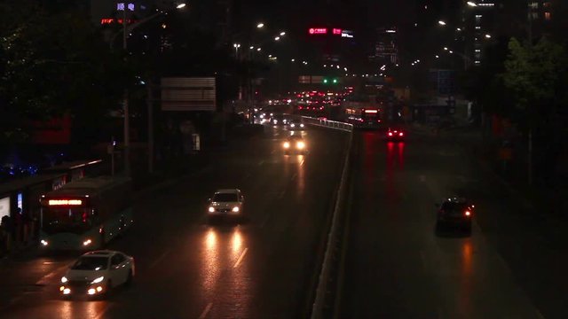 Shekou, Nanshan district Shenzhen, Guangdong province, China; cars and vehicles moving slowly at streets at night;