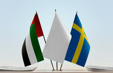 Flags of UAE and Sweden with a white flag in the middle