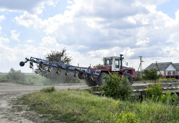 Fototapeta premium Plow on trailer for tractor. Plow for plowing soil. Trailer Hitch for tractors and combines. Trailers for agricultural machinery.
