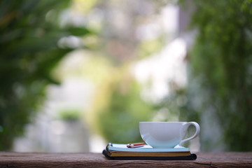 white cup and diary note