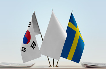 Flags of South Korea and Sweden with a white flag in the middle