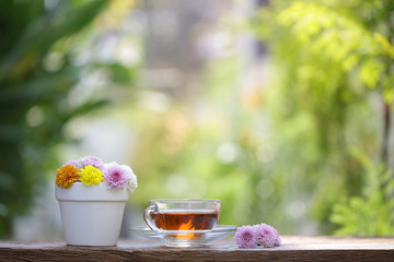 Red tea glass with colorful flowers in white vintage pot