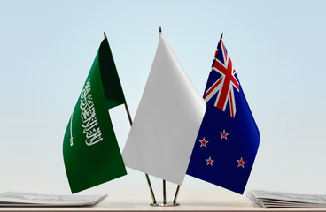 Flags of Saudi Arabia and New Zealand with a white flag in the middle