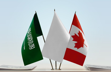 Flags of Saudi Arabia and Canada with a white flag in the middle