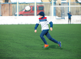 Obraz premium kids play football on the stadium at winter. soccer training. active lifestyle ,winter tornament
