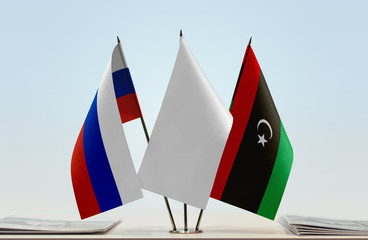 Flags of Russia and Libya with a white flag in the middle