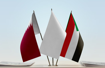 Flags of Qatar and Sudan with a white flag in the middle