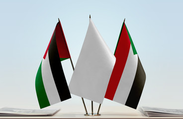 Flags of Palestine and Sudan with a white flag in the middle