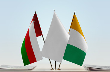 Flags of Oman and Ivory Coast with a white flag in the middle