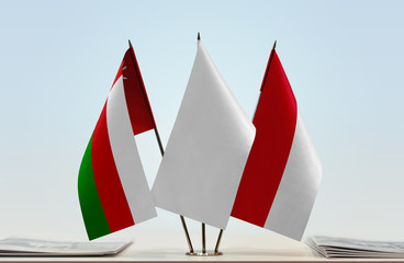 Flags of Oman and Monaco with a white flag in the middle