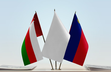 Flags of Oman and Liechtenstein with a white flag in the middle