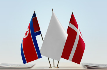 Flags of North Korea and Denmark with a white flag in the middle
