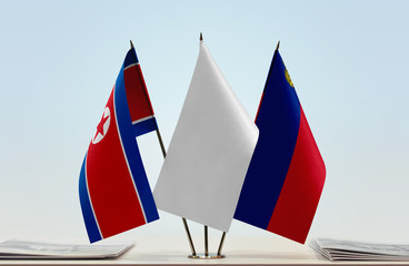 Flags of North Korea and Liechtenstein with a white flag in the middle