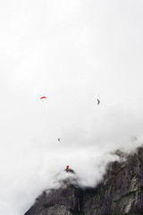 Hang gliders in Pedra da Gavea on a cloudy day