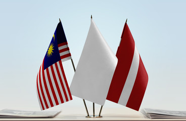 Flags of Malaysia and Latvia with a white flag in the middle