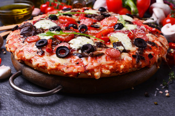 Excellent Italian pizza with cheese and tomatoes, and olives