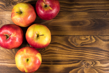 Red apples on wooden table. Top view, copy space