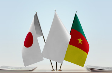 Flags of Japan and Cameroon with a white flag in the middle