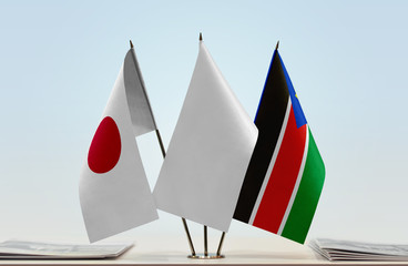 Flags of Japan and South Sudan with a white flag in the middle