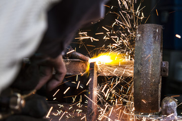 the worker cutting steel