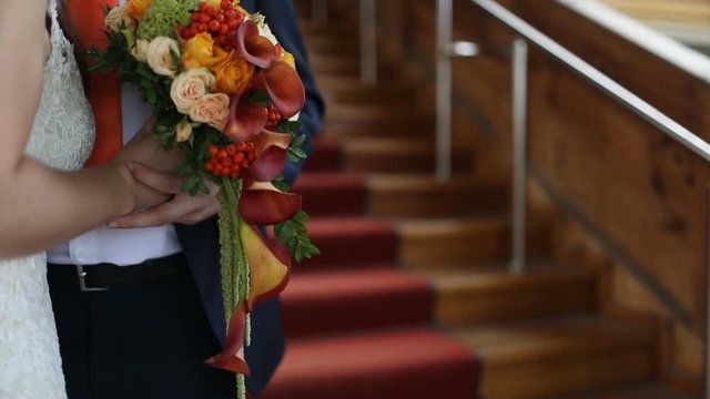 Beautiful wedding bouquet in hands of the bride