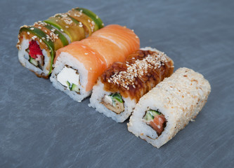 Sushi on stone black background 

