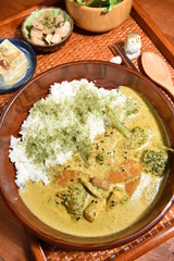 A set menu green curry with rice, salad and tofu . 