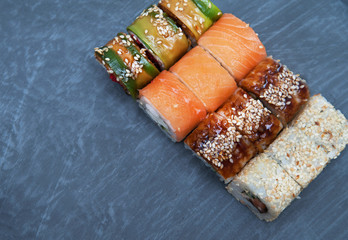 Sushi on stone black background 

