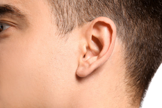 Young man, closeup. Hearing problem